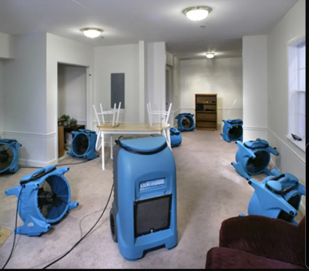 Air movers and dehumidifier setup for Water Damage Restoration in Victor